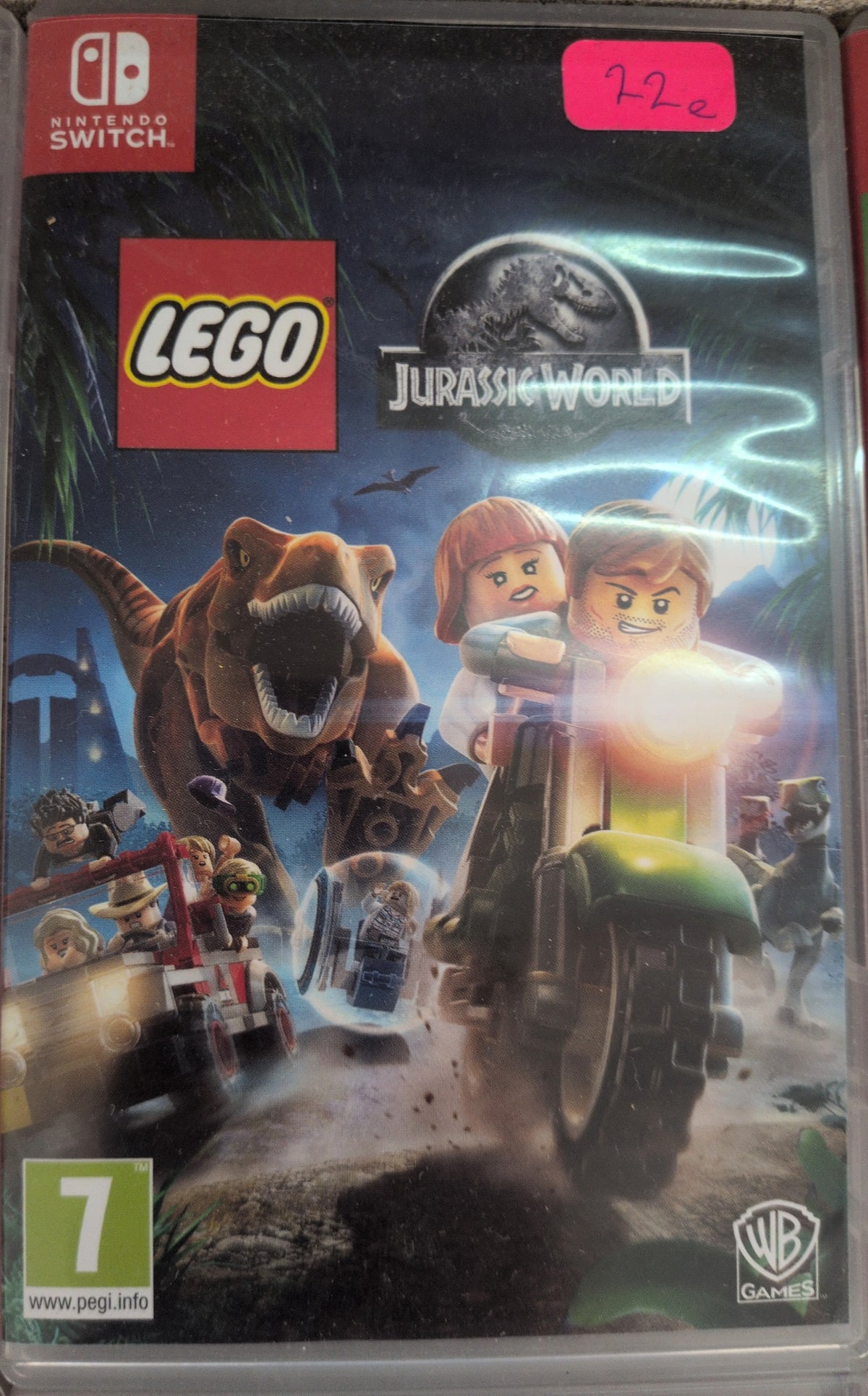 Photographed front cover and case of LEGO Jurassic World for Nintendo Switch, pink sticker copy