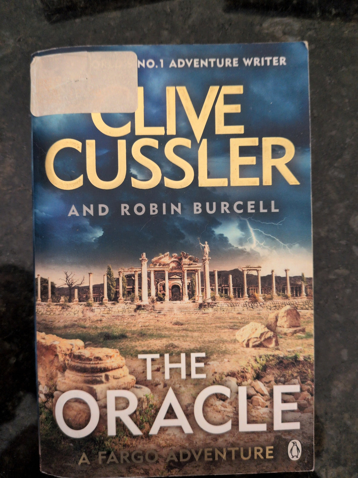 Actual photographed front cover of The Oracle by Clive Cussler and Robin Burcell