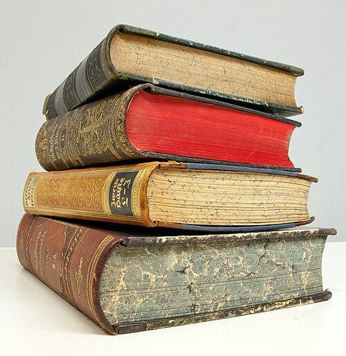 A stack of old hardback books